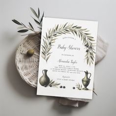 a baby shower is shown on top of a wicker basket next to an olive branch