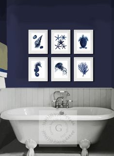 a bathroom with blue walls and pictures on the wall above the claw foot bathtub