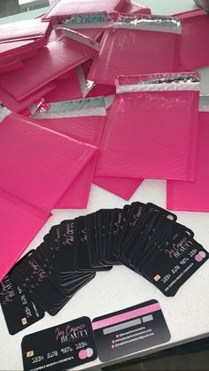 some pink cards are laying on a table