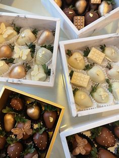 four boxes filled with assorted chocolates on top of a table