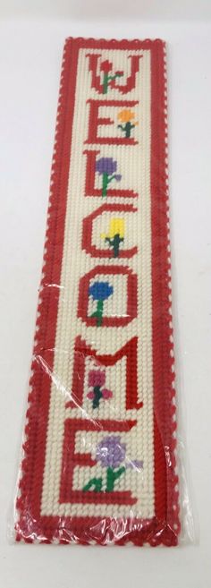 a red and white table runner with the word love spelled in small letters on it