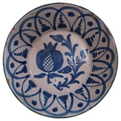 a blue and white bowl with designs on it