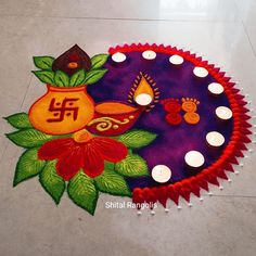 a decorated diya with candles on the floor