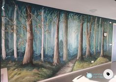 a painting on the wall of a room with trees