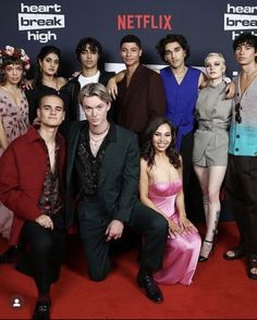 a group of people posing for a photo on the red carpet