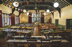 an empty dining hall with tables and chairs