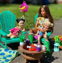 two dolls are sitting in lawn chairs with toys