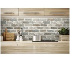 an image of a kitchen setting with bricks on the wall and counter tops in front of it