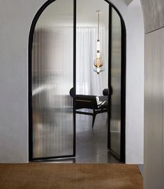 an arched glass door leading to a dining room