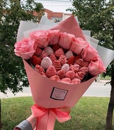 a bouquet of chocolates wrapped in pink paper