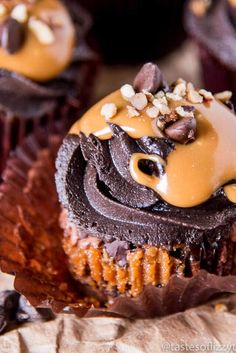 cupcakes with chocolate frosting and nuts on top