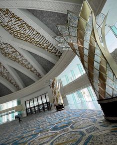 the inside of a large building with many windows and decorative designs on it's walls