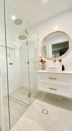 a bathroom with a sink, mirror and walk in shower