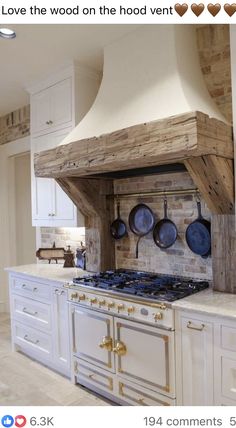 a kitchen with an oven, range and pots on the stove top that is made out of wood