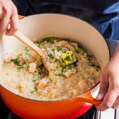 a person stirring food in a pot on the stove