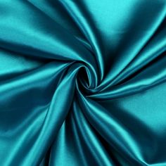 a close up view of a teal satin fabric