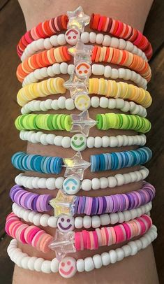 the bracelets are stacked on top of each other with different colored beads and charms