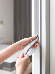 a woman is opening the door with her hand