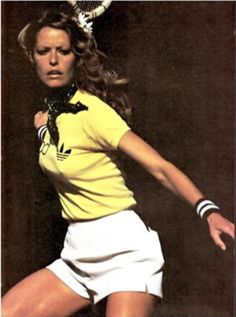 a woman swinging a tennis racquet on top of a tennis court with her racket