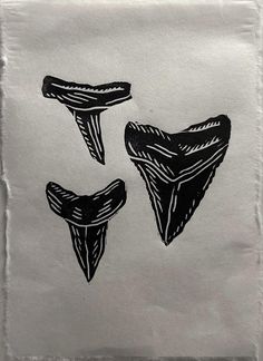 two pieces of paper with black ink on them, one is shaped like an upside down triangle