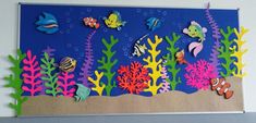 an underwater scene made out of paper with fish and corals on the bottom half