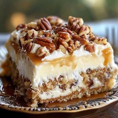 a piece of cheesecake with pecans on top is sitting on a decorative plate