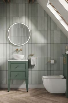 a white toilet sitting under a bathroom mirror next to a green vanity and sink in a room