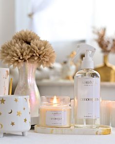 a white table topped with candles and bottles