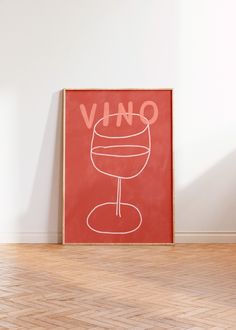 a red poster with the word vino on it in front of a white wall