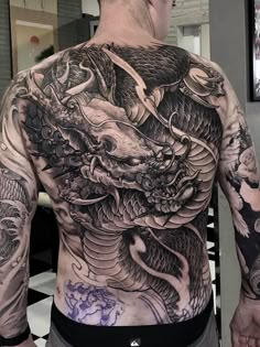 a man with a dragon tattoo on his back