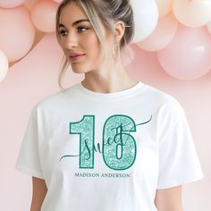 a woman wearing a white tshirt with the number sixteen on it and balloons in the background