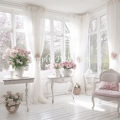 a room filled with lots of white furniture and flowers in vases on the windowsill