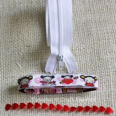 a white zipper with red hearts on it