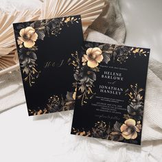 two black and gold wedding cards with flowers on them