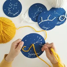 someone is knitting yarn on top of some blue paper with stars and the word scorp written across it