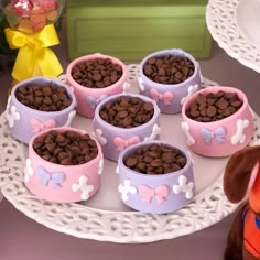 there are dog bowls with chocolate chips in them on a plate next to a stuffed animal