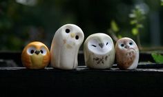 five small owls sitting on top of a wooden table