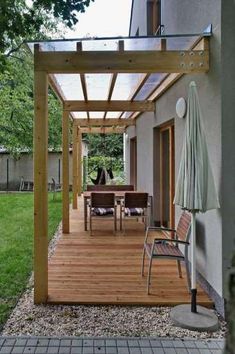 a wooden deck with chairs and an umbrella