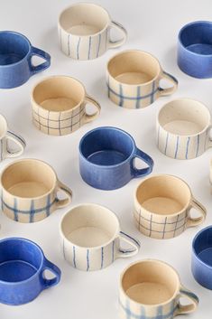 many blue and white cups sitting on top of each other