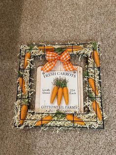 an orange carrot frame with a ribbon on it