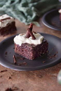 two pieces of chocolate cake with white frosting