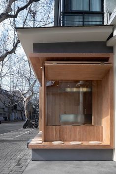 an outdoor sauna in the corner of a building