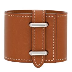 This is an authentic HERMES Barenia Izy Cuff size S in Fauve. This stylish bracelet is crafted of luxurious calfskin leather in brown. There is a strap at one end that fits through a 2 slots in the bracelet and secures with a leather loop. Modern Brown Bracelets For Formal Occasion, Luxury Leather Bracelets For Business, Classic Double Band Leather Bracelets, Elegant Leather Bracelet With Palladium Hardware, Modern Brown Leather Bracelet With Wrist Strap, Luxury Adjustable Open Cuff Bracelet, Luxury Leather Strap Bracelets, Luxury Leather Strap Bracelets For Business, Leather Double Band Bracelet With Leather Strap