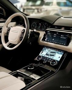 the interior of a modern car with dashboard, steering wheel and dash board on display