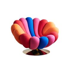 a colorful chair sitting on top of a metal base