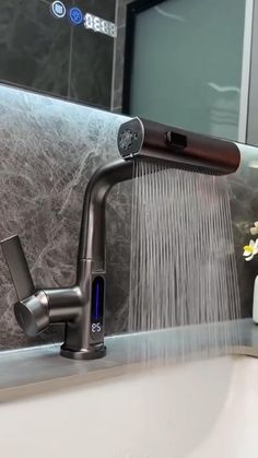 a faucet running water from a sink in a bathroom