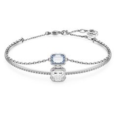 Enjoy two styles in one with this fascinating Chroma bangle. The rhodium plated design features a solid band embellished with clear crystals and a clear stone at the center, while the soft chain holds a rectangular-shaped Swarovski Zirconia in blue. Both stones are surrounded by clear square-cut crystals on the sides for added radiance. The piece has a lobster closure with an elongation for an adjustable fit. Inspired by drops of light, this beautiful bangle is the epitome of understated glamour Blue Crystal Bracelet, Adjustable Bangle, Elegant Bracelet, Clear Stone, Clear Crystals, Strand Bracelet, Swarovski Jewelry, Pink Stone, Single Earring