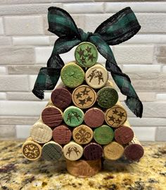 a christmas tree made out of wine corks with a green bow on the top