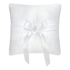 a white pillow with a bow on it