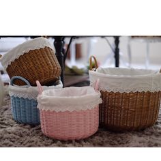 three wicker baskets sitting on top of a rug